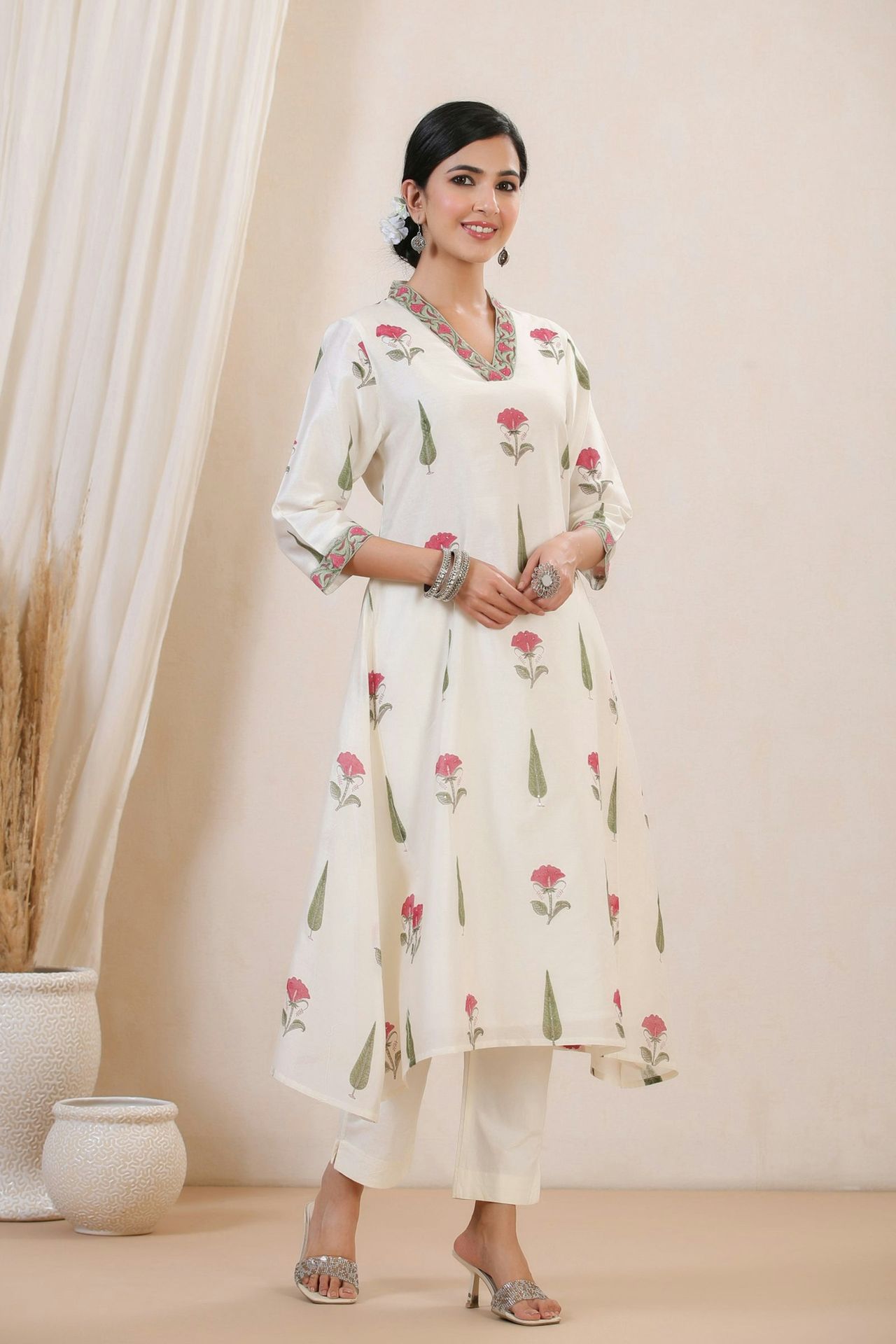 A woman is wearing a floral white outfit.